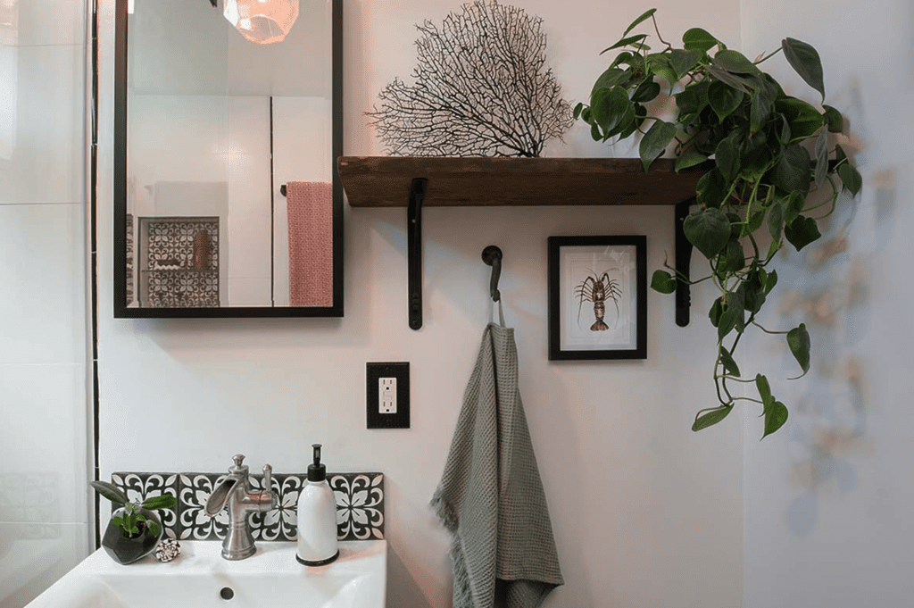 Cozy bathroom corner with plants and artistic decor.